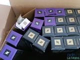 a cardboard box filled with purple and black boxes