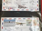 two airmails with stamps on them sitting on a red surface