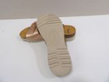 someone is wearing a pair of sandals that are on a white surface