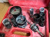 a red tool case with tools in it on the floor
