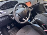 the interior of a small car with a steering wheel and dashboard