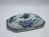 a small blue and white plate with a bird on it