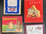 trois livres pour enfants sont posés sur une table les uns à côté des autres