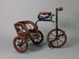 a toy carriage with a bird sitting on top of it