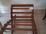 a wooden bed frame on the floor in a room