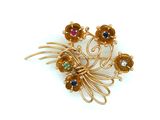 yellow gold plated brooch with multi colored stones on it
