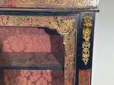 a black and gold cabinet with a red and gold pattern on it