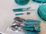 a lot of blue plates and silverware on the table