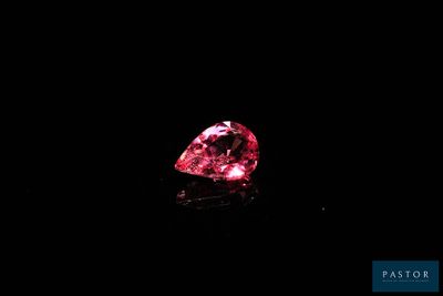 a pink diamond on a black background