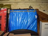 a blue tarp covering the back of a bed