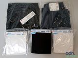 four pairs of black and white shirts in plastic bags