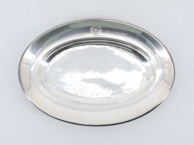 a silver plate on a white surface with a silver handle