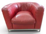 un fauteuil en cuir rouge posé sur une surface blanche