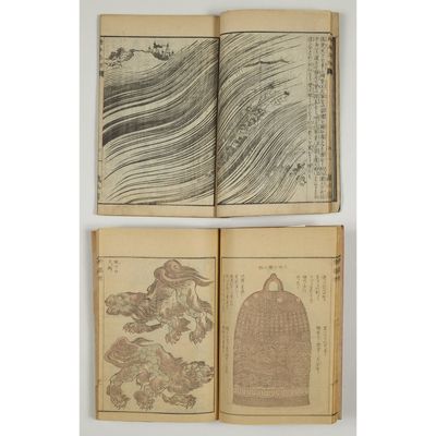 a set of four old books with drawings on them