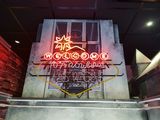 a neon sign that says welcome to the restaurant