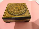 a small wooden box with a decorative design on it