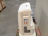a white refrigerator sitting on a pallet in a warehouse