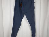 blue pants hanging on a hanger in front of a white curtain