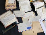 many letters and envelopes sitting on a table