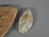 a piece of bread and a piece of stone on a table