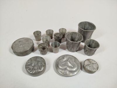 some silver metal objects are sitting on a white surface