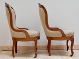 pair of antique chairs with upholstered back and arms on casteors