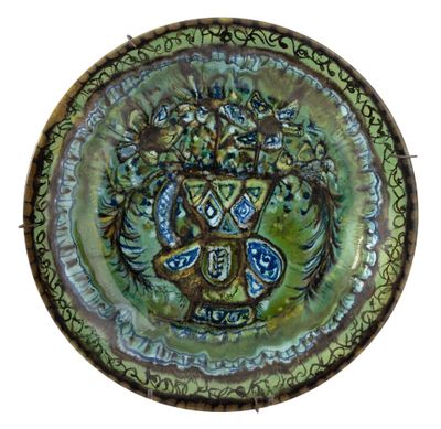 a green plate with a design on it on a white background