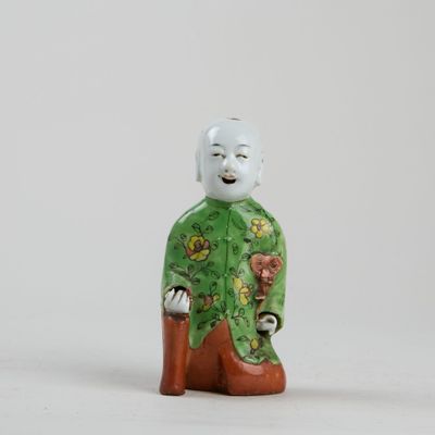 a small figurine of a man in a green outfit