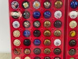 two red boxes filled with different types of buttons