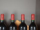 three bottles of red wine are lined up in a row