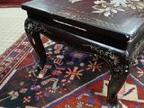 a black table with a floral design on top of it