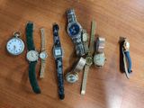 a lot of different watches on a table together