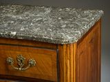 a marble top on a wooden chest of drawers