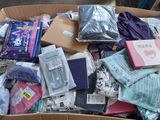 a cardboard box full of clothes and other items