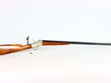 rifle on a white background with a black handle and a brown barrel