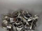 a pile of silver spoons and other silverware on a table