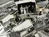 several old black and white photos of people and boats on a table