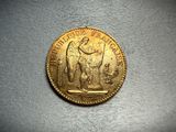 an image of a gold coin with a statue on top of it