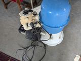 a blue water tank sitting on the floor next to a red chair