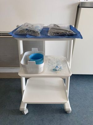 a white cart with a blue tray on top of it
