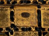 a close up of a gold cross on a blue surface