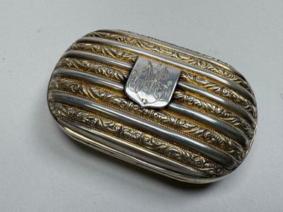 an image of a silver and gold box with a stone in it