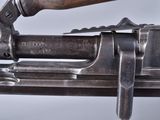 a close up of a gun with a wooden handle
