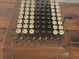 an old fashioned typewriter sitting on top of a wooden table