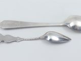 two spoons and a spoon spoon on a white surface