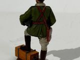 a figurine of a man with a suitcase and a hat
