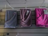 several towels are hanging on a rack in a store