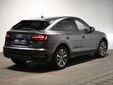 the rear end of a silver audi suv parked in a garage