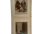 an old photo of a couple of people sitting next to each other