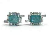 an image of a pair of emerald and diamond earrings on a white background